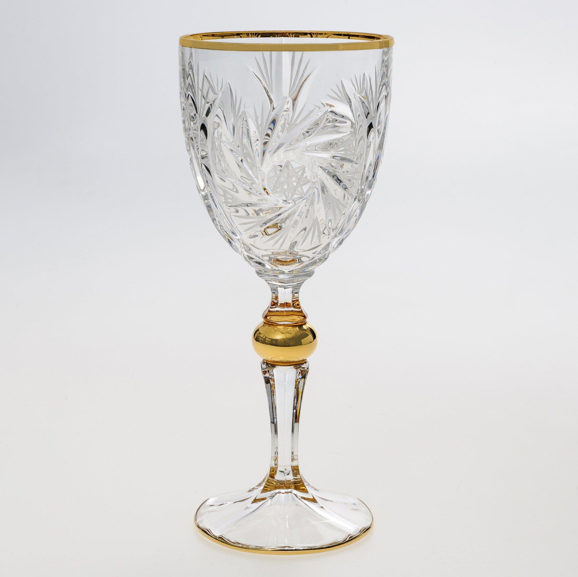 Crystal wine glass with pinwheel design and gold touches